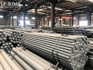 Steel structure manufacturing workshop, neatly stacked prefabricated tubular steel components ready for fabrication, transportation and installation. LF-BJMB industrial steel structure production for large-span storage facilities.