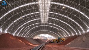 Clinker Storage Shed Interior Interior of arched space frame clinker storage shed with clinker stockpiles, wheel loader and belt conveyor