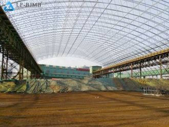 A large-span arched steel coal storage shed project with white metal cladding roof, used as an illustration of the coal storage shed construction cost article